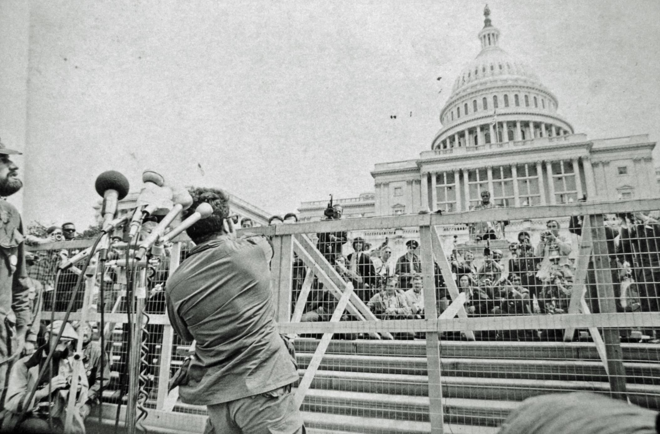 “A Vietnam veteran throws his war medal at the Capitol building in protest of the war. April 23, 1971.”